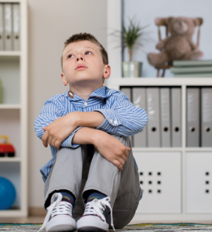 Autistic boy sitting on floor
