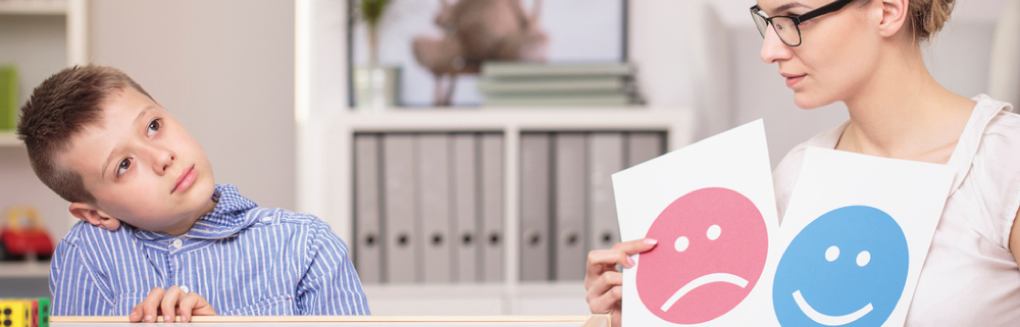 Boy with a mental health teacher showing him some posters