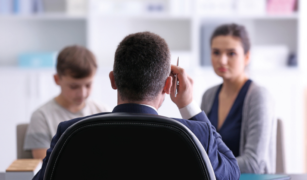 Parent and child with teacher at School Parents Evening